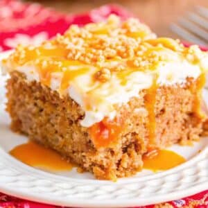 carrot poke cake with sweetened condensed milk topped with whipped cream