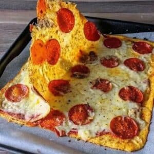 onion ring pizza style baked with melted mozzarella and pepperoni on tray